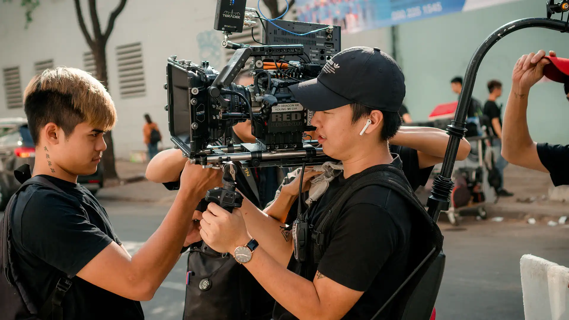 Crew operating a cinema camera rig on a city street during the shoot